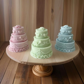Front view of SS Enterprise Organic Soy Wax Cake Shape Designer Candles Set of 3 in green, pink, and blue