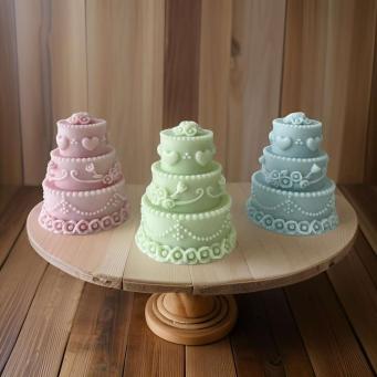 Front view of SS Enterprise Organic Soy Wax Cake Shape Designer Candles Set of 3 in green, pink, and blue